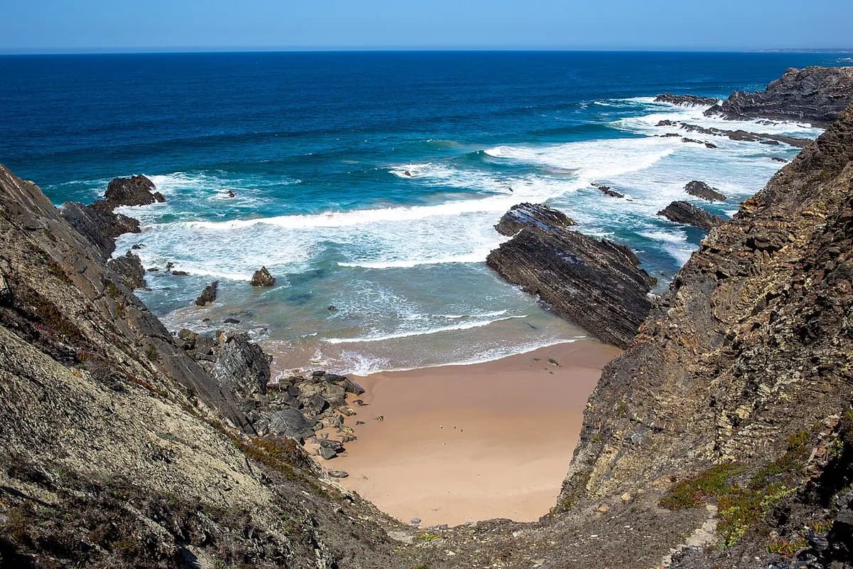 Praia da Amalia hidden beach with waterfall and dramatic cliffs on the southern Alentejo coast