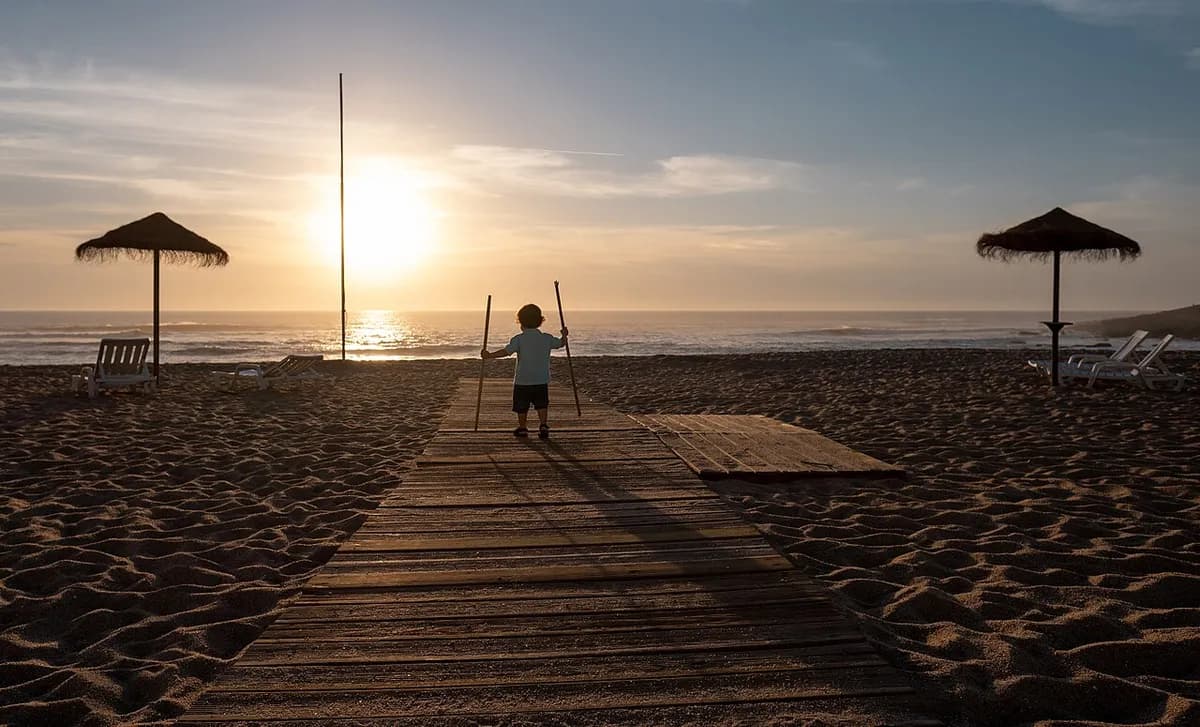 Praia das Amoeiras dog beach with traditional palheiro shelters in Santa Cruz, Torres Vedras